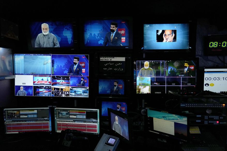 TV anchor Nesar Nabil is seen on studio monitors wearing a face mask to protest the Taliban's new order that female presenters cover their faces, as he reads the news on TOLOnews, in Kabul, Afghanistan, Sunday, May 22, 2022. (AP Photo/Ebrahim Noroozi, File)