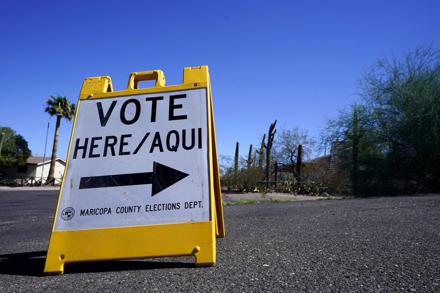 A sign marks the entrance to a voting precinct on the first day of early voting in the general election in Phoenix, Oct. 12, 2022. (AP Photo/Ross D. Franklin, File)