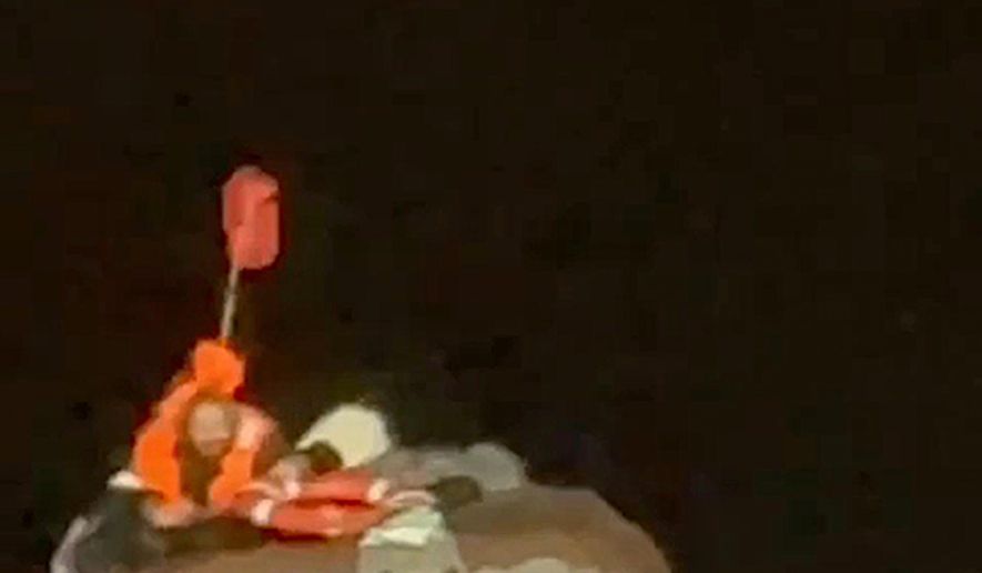 In this photo taken from video released by the official telegram channel of the Russian Far Eastern Transport Prosecutor's Office on Tuesday, Oct. 15, 2024, a Russian man who spent more than two months adrift in an inflatable boat is seen before being rescued by a fishing vessel in the Okhotsk Sea near the village of Ust-Khairuzovo in Kamchatka region of Russian far east. (Official telegram channel of the Russian Far Eastern Transport Prosecutor's Office via AP)