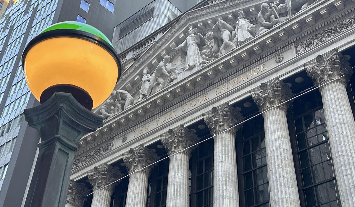 NextImg:Wall Street holds steadier a day after sliding from its record