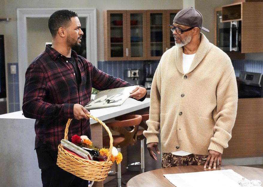 This image released by CBS shows Damon Wayans, Jr., left, and Damon Wayans in a scene from "Poppa's House." (Robert Voets/CBS via AP)