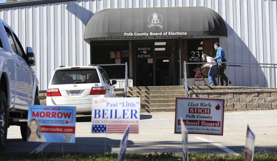 People head inside the Polk County, North Carolina, Board of Elections on the first day of early voting in the state on Thursday, Oct. 17, 2024, in Columbus, N.C. (AP Photo/Jeffrey Collins) ** FILE **