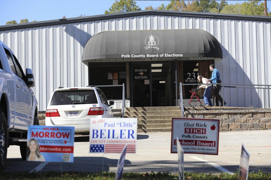 People head inside the Polk County, North Carolina, Board of Elections on the first day of early voting in the state on Thursday, Oct. 17, 2024, in Columbus, N.C. (AP Photo/Jeffrey Collins) ** FILE **