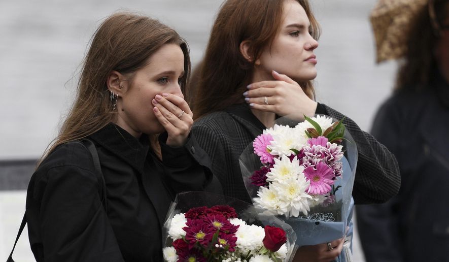 Fans gather for a vigil with flowers to pay tribute to late British singer Liam Payne, former member of the British pop band One Direction in Hyde Park in London, Sunday, Oct. 20, 2024, in London. (Photo by Scott A Garfitt/Invision/AP)
