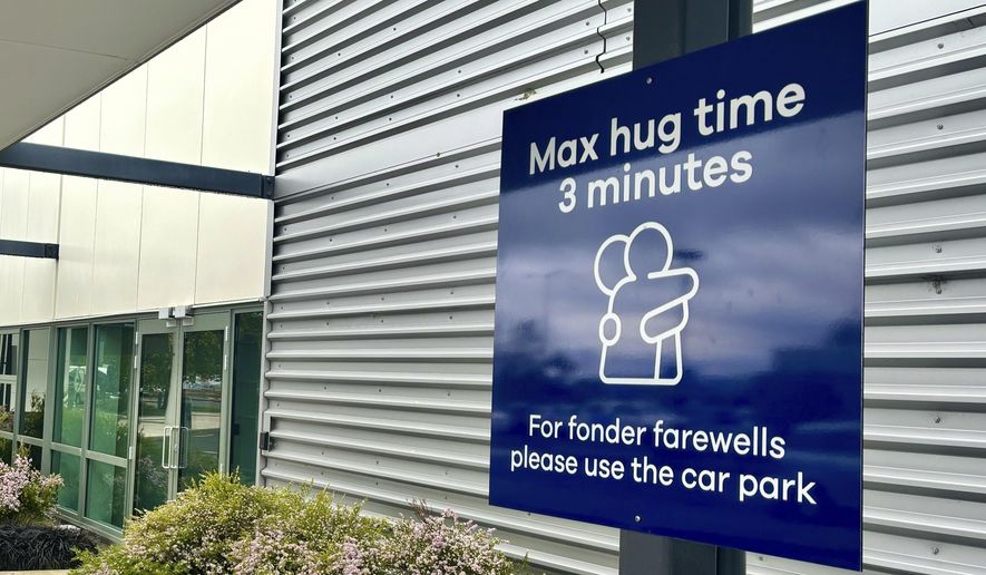 A sign informing time limits for visitors to the passenger drop-off area outside Dunedin Airport in Momona, New Zealand, Tuesday, Oct. 22, 2024. Travelers wanting to embrace for longer can relocate to the parking lot. (Sarah Soper/Dunedin Airport via AP)