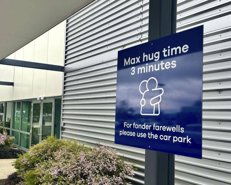 A sign informing time limits for visitors to the passenger drop-off area outside Dunedin Airport in Momona, New Zealand, Tuesday, Oct. 22, 2024. Travelers wanting to embrace for longer can relocate to the parking lot. (Sarah Soper/Dunedin Airport via AP)