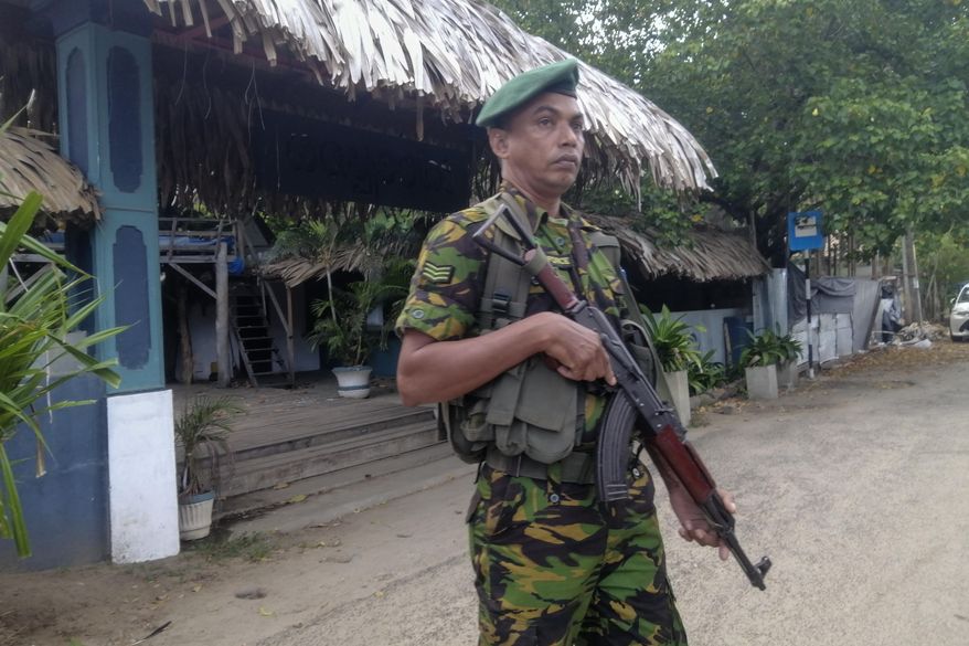 A police commando stands guard in front of a restaurant in Arugam Bay, Sri Lanka, Wednesday, Oct. 23, 2024. (AP Photo/Wasantha Chandrapala)