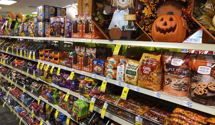 Halloween candy and decorations are displayed at a store, Wednesday, Sept. 23, 2020, in Freeport, Maine. U.S. sales of In this year of the pandemic, with trick-or-treating still an uncertainty, Halloween candy were up 13% over last year in the month ending Sept. 6, according to data from market research firm IRI and the National Confectioners Association. (AP Photo/Robert F. Bukaty)