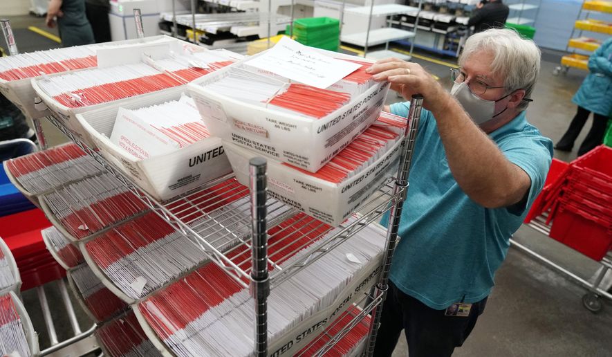 An election worker sorts mail-in ballots at the Multnomah County Duniway-Lovejoy Elections Building Monday, Nov. 2, 2020, in Portland, Ore. (AP Photo/Marcio Jose Sanchez, File)