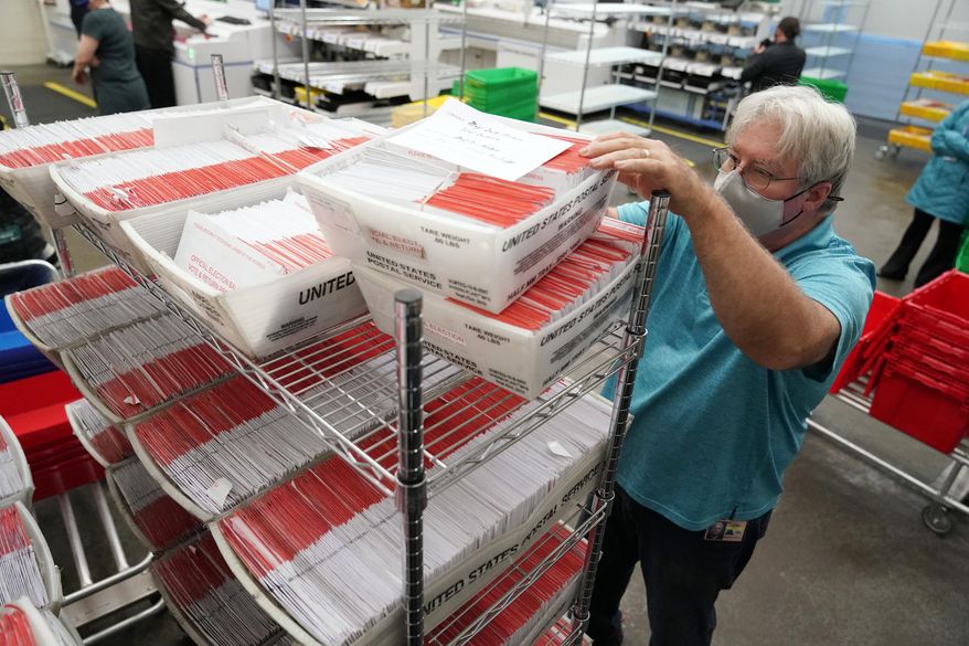 An election worker sorts mail-in ballots at the Multnomah County Duniway-Lovejoy Elections Building Monday, Nov. 2, 2020, in Portland, Ore. (AP Photo/Marcio Jose Sanchez, File)