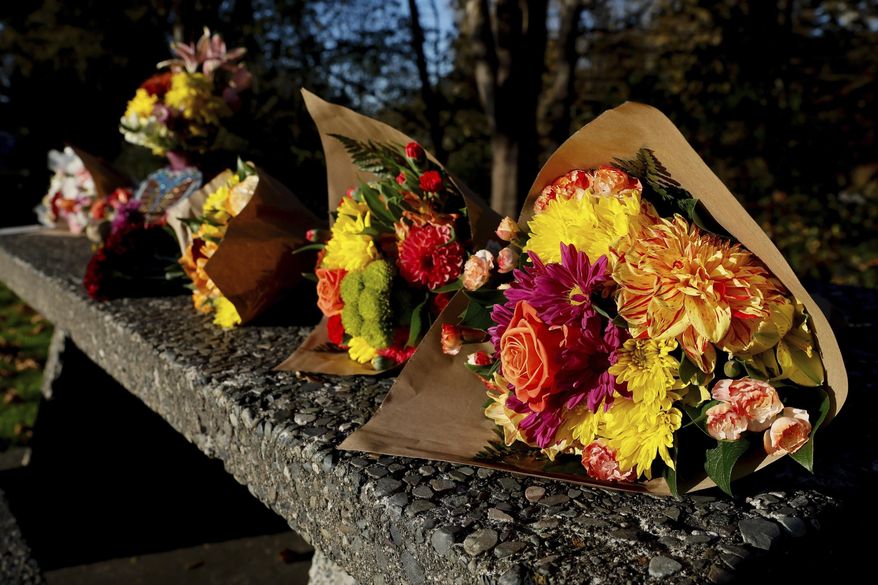 Bouquets line a stone picnic table at a roadside park as a small memorial to the victims of a mass shooting the day before in Fall City, Wash., Tuesday, Oct. 22, 2024. (Jennifer Buchanan/The Seattle Times via AP, File)
