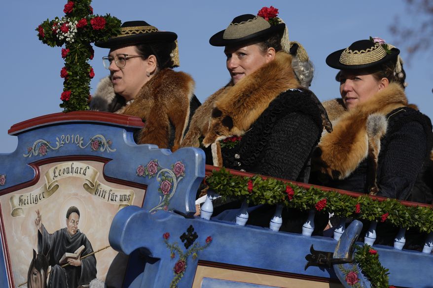 Women in traditional costumes of the region take part at the traditional Leonhardi pilgrimage in Warngau near Munich, Germany, Sunday, Oct. 27, 2024. The annual pilgrimage honors St. Leonhard, patron saint of the highland farmers for horses and livestock. (AP Photo/Matthias Schrader)