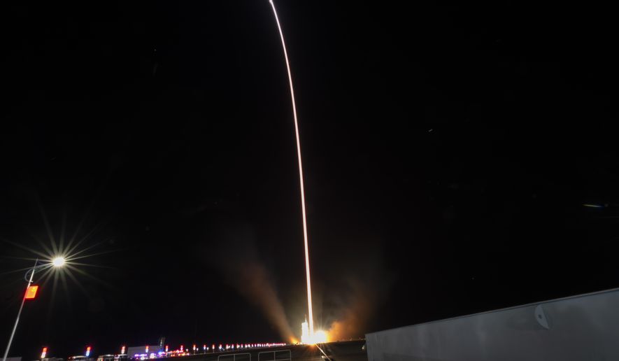 In this image taken with a long exposure, a Long March rocket with a Shenzhou-19 spacecraft atop takes off from the Jiuquan Satellite Launch Center in Jiuquan, northwestern China in the early hours of Wednesday, Oct. 30, 2024. (AP Photo/Ng Han Guan)