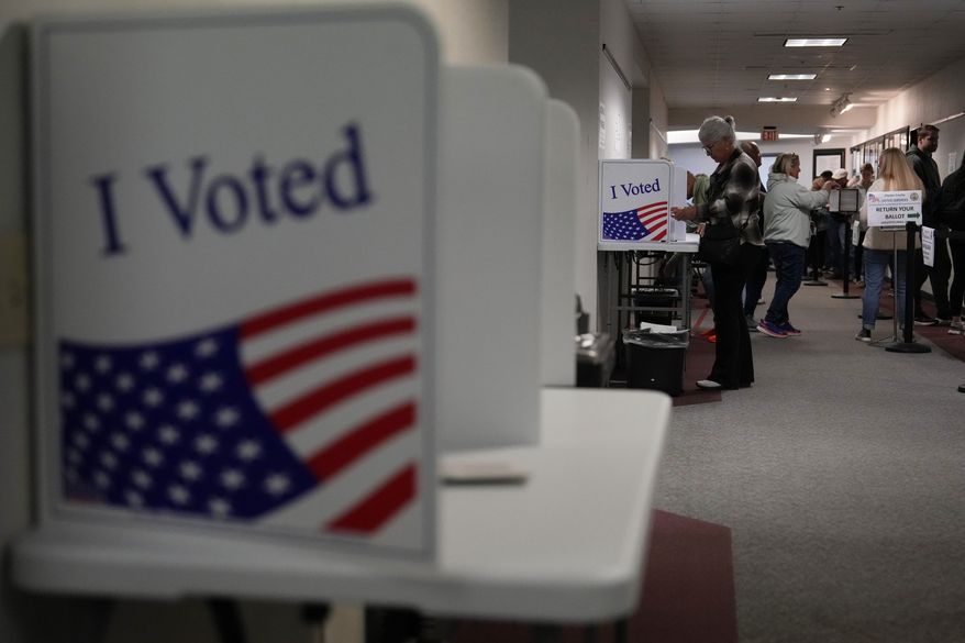 People fill out mail-in ballots for the 2024 General Election in the United States at a Voters Services satellite office at the Chester County Government Services Center, Friday, Oct. 25, 2024, in West Chester, Pa. (AP Photo/Matt Slocum)