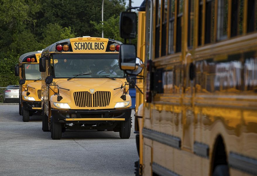 Jefferson County Public Schools buses make their way through the Detrick Bus Compound on the first day of school in Louisville, Ky., on Wednesday, Aug. 9, 2023. (Jeff Faughender/Courier Journal via AP) **FILE**