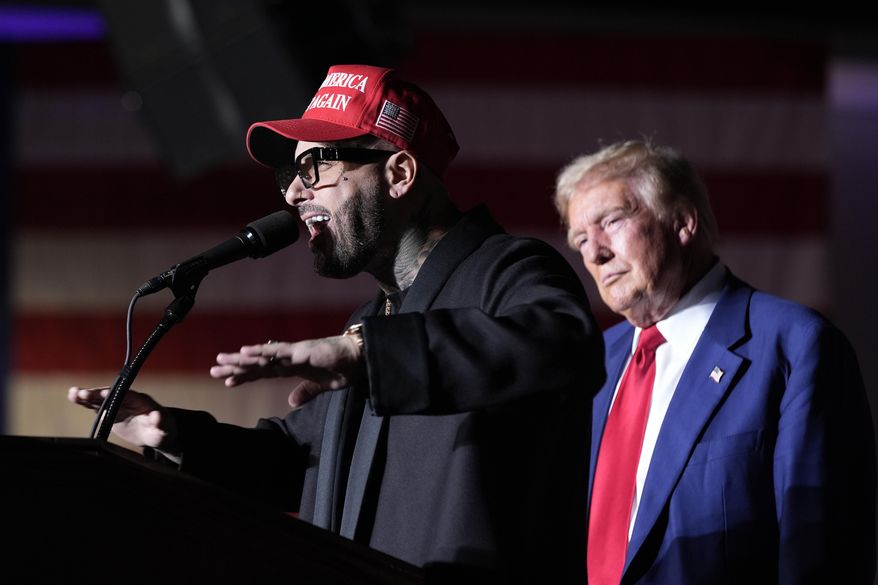 Nicky Jam speaks as Republican presidential nominee former President Donald Trump listens during a campaign event at the World Market Center, Sept. 13, 2024, in Las Vegas. (AP Photo/Alex Brandon, File)