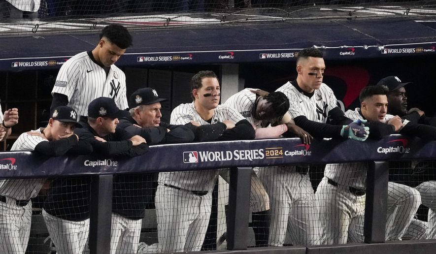 The New York Yankees watch during their loss against the Los Angeles Dodgers in Game 5 of the baseball World Series, Wednesday, Oct. 30, 2024, in New York. (AP Photo/Frank Franklin II)