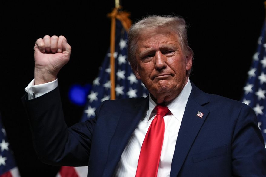 Republican presidential nominee former President Donald Trump gestures after a Tucker Carlson Live Tour show at Desert Diamond Arena, Thursday, Oct. 31, 2024, in Glendale, Ariz. (AP Photo/Julia Demaree Nikhinson)