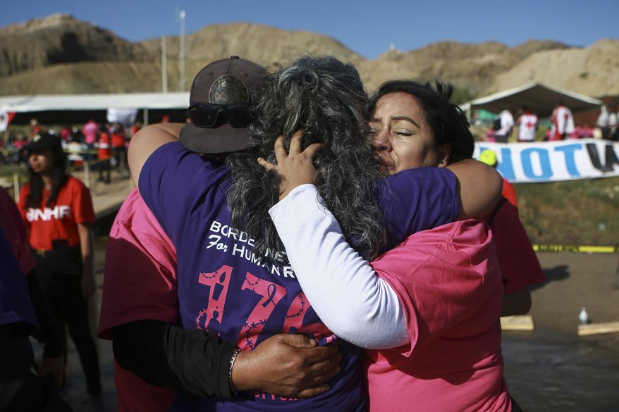 People living in Mexico meet with relatives living in the U.S., during the annual "Hugs not Walls" event on a stretch of the Rio Grande, in Ciudad Juarez, Mexico, Saturday, Nov. 2, 2024. (AP Photo/Christian Chavez)