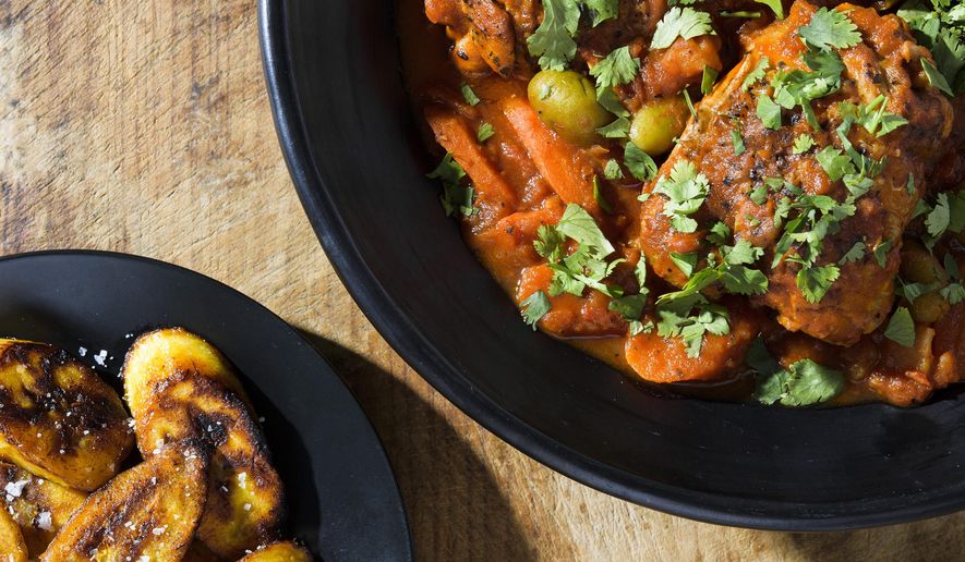 This image released by Milk Street shows a recipe for chicken fricase with tomatoes, potatoes and carrots. (Milk Street via AP)