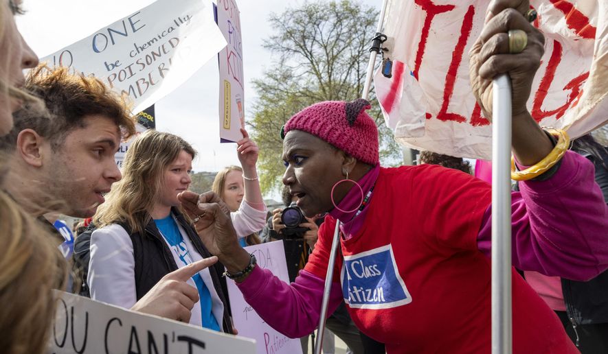 FILE – Pro-life activist Caleb Buck, left, argues with abortion-rights activist Nadine Seiler outside the Supreme Court, Tuesday, March 26, 2024, in Washington. (AP Photo/Amanda Andrade-Rhoades, File)