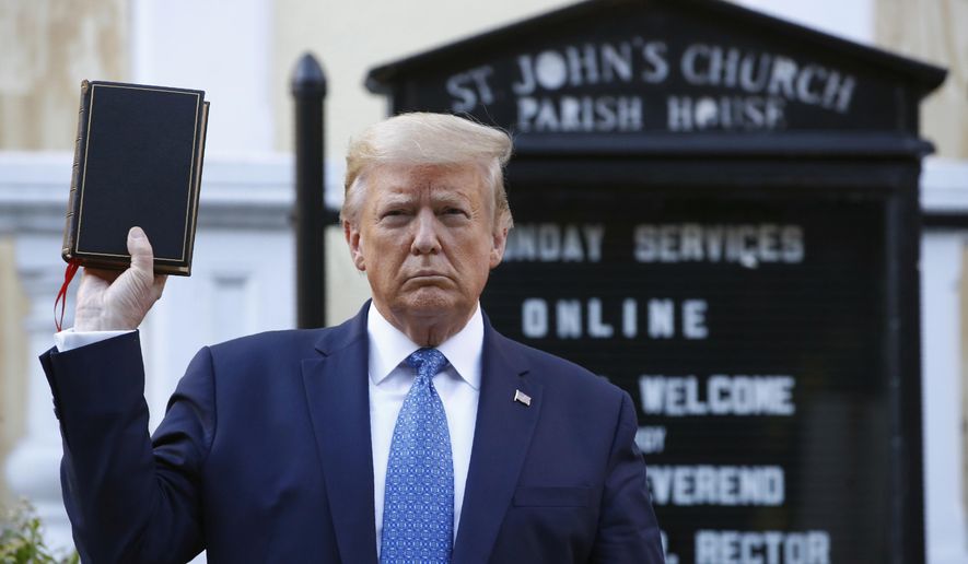 President Donald Trump holds a Bible as he visits outside St. John's Church, June 1, 2020, in Washington. (AP Photo/Patrick Semansky, File)