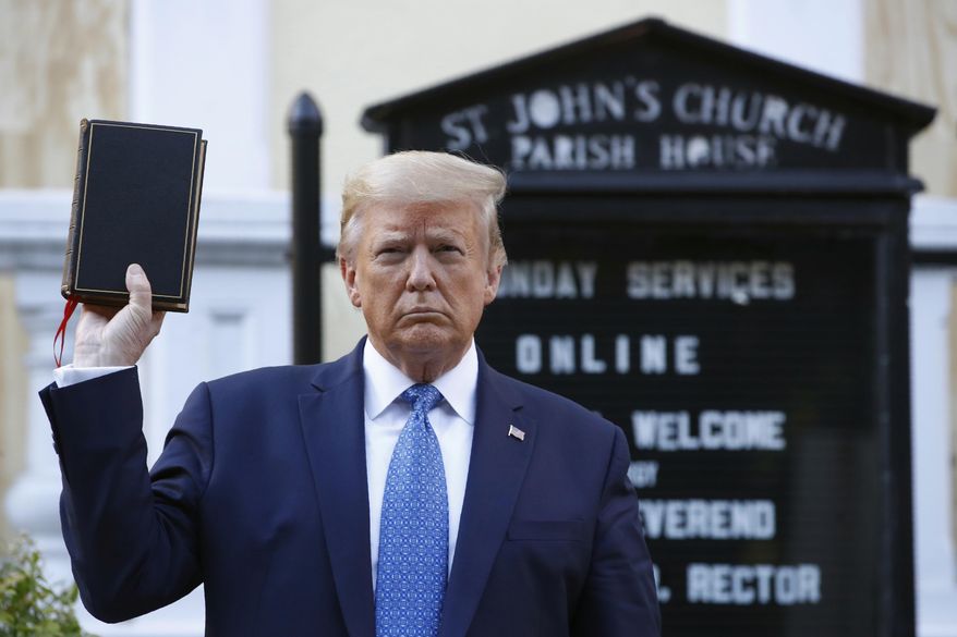 President Donald Trump holds a Bible as he visits outside St. John's Church, June 1, 2020, in Washington. (AP Photo/Patrick Semansky, File)