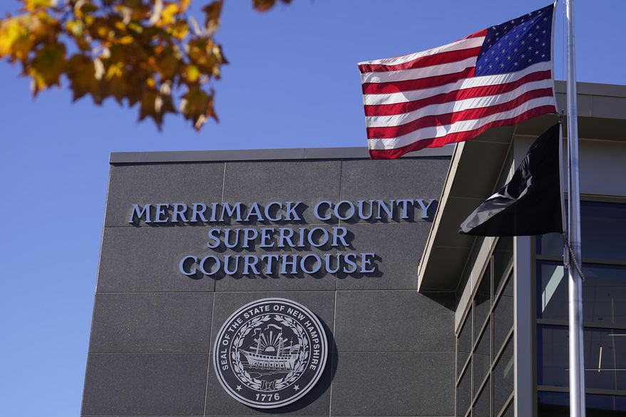 FILE - An American flag flies outside Merrimack County Superior Courthouse in Concord, N.H., Sunday, Oct. 11, 2020. (AP Photo/Charles Krupa, File)