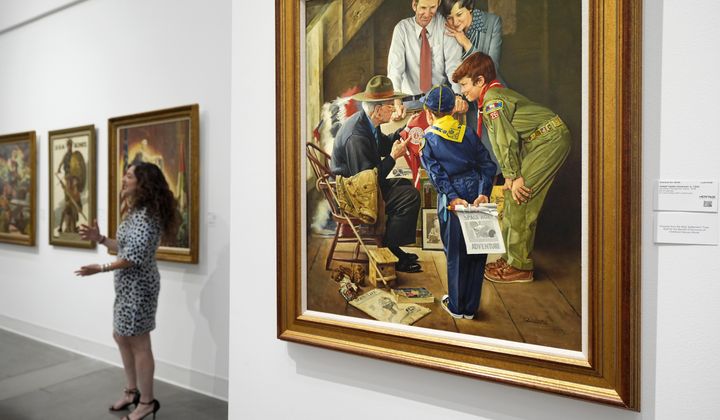 Aviva Lehmann, Heritage Auction's senior vice president of American art, responds to a question as she stands by paintings in Dallas, Thursday, Oct. 17, 2024, that are some of many works from the Boy Scouts of America's art collection — including some paintings by Norman Rockwell — that will go up for auction this month to help compensate tens of thousands of people, mainly men, who were sexually abused while in scouting. (AP Photo/Tony Gutierrez)