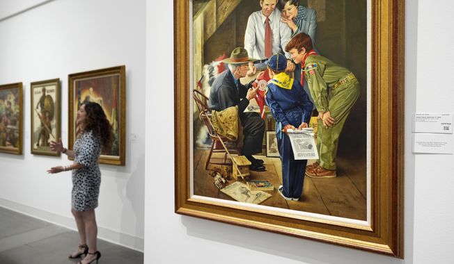 Aviva Lehmann, Heritage Auction's senior vice president of American art, responds to a question as she stands by paintings in Dallas, Thursday, Oct. 17, 2024, that are some of many works from the Boy Scouts of America's art collection — including some paintings by Norman Rockwell — that will go up for auction this month to help compensate tens of thousands of people, mainly men, who were sexually abused while in scouting. (AP Photo/Tony Gutierrez)