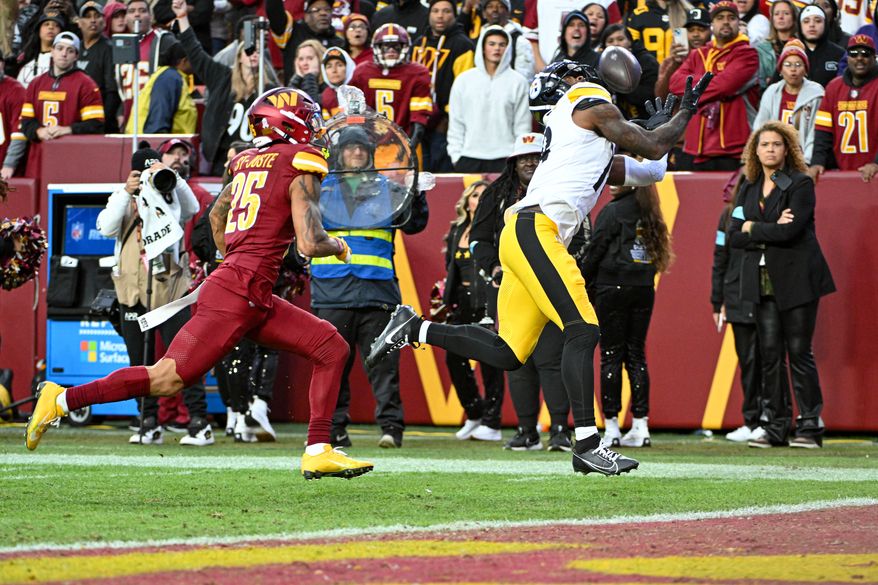 Pittsburgh Steelers wide receiver Mike Williams (18) catching a 32-yard touchdown pass from quarterback Russell Wilson (3) during the second half of an NFL game against the Washington Commanders at Northwest Stadium in Landover, MD, November 10, 2024. (Photo for the Washington Times)