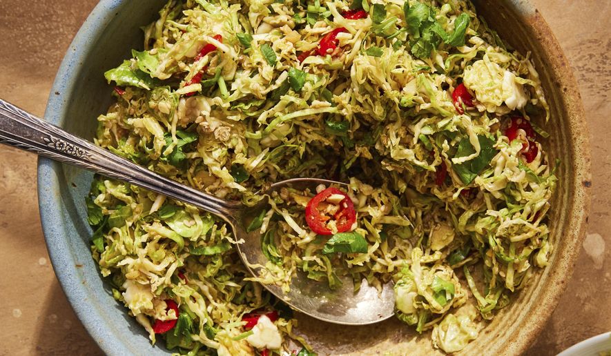 This image released by Milk Street shows a recipe for hot-oil Brussels sprouts with ginger and sesame. (Milk Street via AP)