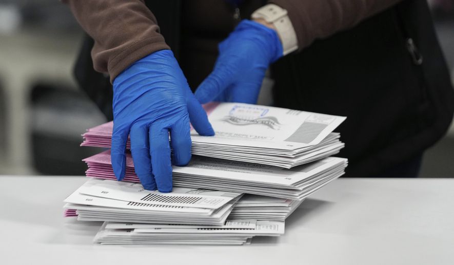 An Election worker sorts mail-in ballots at the Washoe County Registrar of Voters office, Tuesday, Nov. 5, 2024, in Reno, Nev. (AP Photo/Godofredo A. Vásquez)