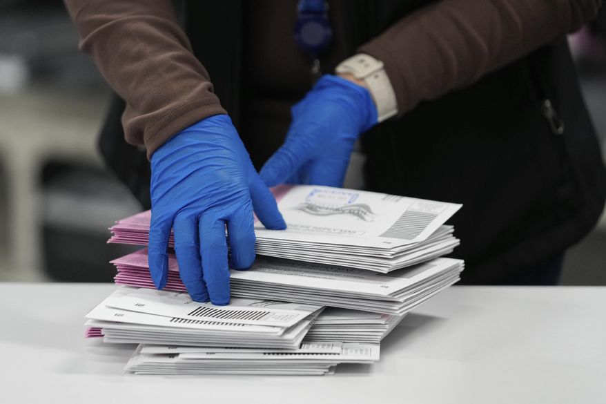 An Election worker sorts mail-in ballots at the Washoe County Registrar of Voters office, Tuesday, Nov. 5, 2024, in Reno, Nev. (AP Photo/Godofredo A. Vásquez)