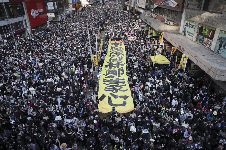 Pro-democracy protesters march on a street during a protest in Hong Kong, on Dec. 8, 2019. (AP Photo/Kin Cheung, File)