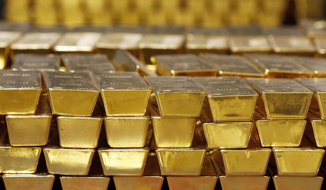 Gold bars are shown stacked in a vault at the U.S. Mint on July 22, 2014, in West Point, N.Y. (AP Photo/Mike Groll, File)