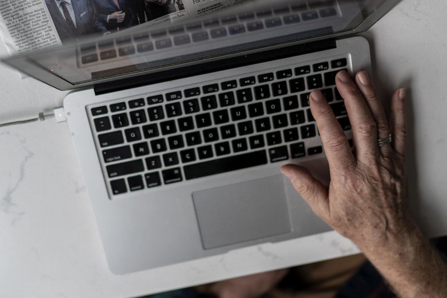 A person works on a laptop computer in Hudson, Wis., on Nov. 16, 2022. (AP Photo/David Goldman) **FILE**