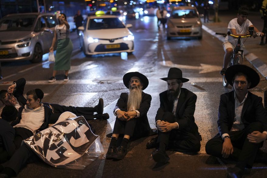 Ultra-Orthodox Jewish men block a road during a protest against army recruitment in Bnei Brak, near Tel Aviv, Israel, Sunday, Nov. 17, 2024. (AP Photo/Francisco Seco) **FILE**
