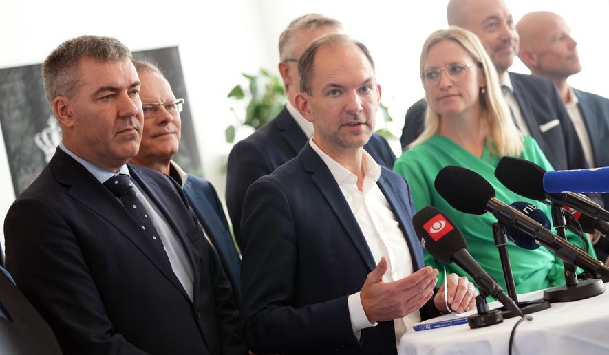 Denmark's Minister for the Green Tripartite Jeppe Bruus, center, and members of the coalition present a political agreement on the so-called green tripartite deal at the ministry in Copenhagen, Denmark, Monday, Nov. 18, 2024. (Ida Marie Odgaard/Ritzau Scanpix via AP)