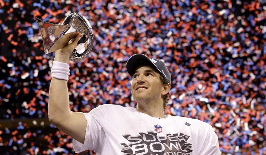 New York Giants quarterback Eli Manning holds up the Vince Lombardi Trophy while celebrating his team's 21-17 win over the New England Patriots in the NFL Super Bowl XLVI football game, Feb. 5, 2012, in Indianapolis. (AP Photo/David J. Phillip, File)
