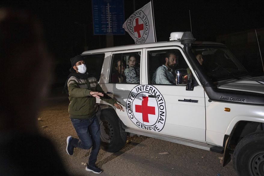 A Red Cross vehicle carrying Israeli hostages drives by at the Gaza Strip crossing into Egypt in Rafah on Nov. 25, 2023. (AP Photo/Fatima Shbair, File)