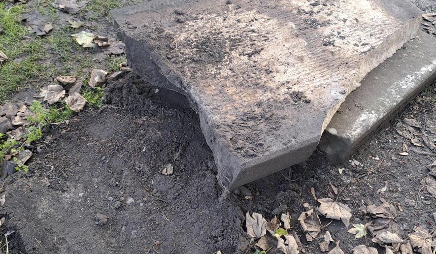 In this picture, provided by the West Mercia Police on Monday, Nov. 25, 2024, a smashed movie prop tombstone that was used for the "A Christmas Carol" movie is seen in Shrewsbury, England. (West Mercia Police via AP)