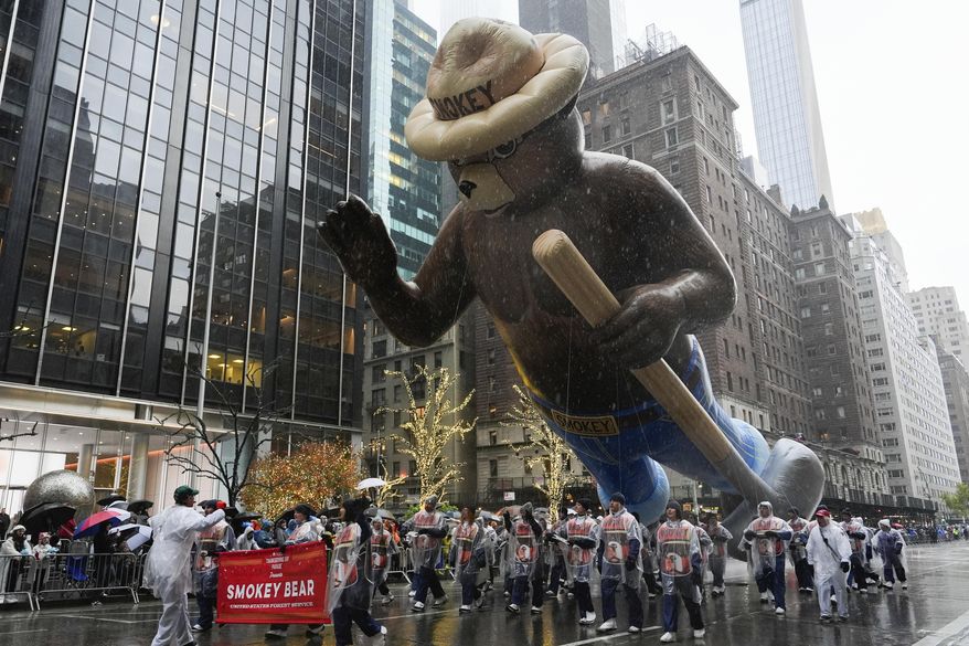 Handlers guide the Smokey Bear balloon down Sixth Avenue during the Macy's Thanksgiving Day Parade, Thursday, Nov. 28, 2024, in New York. (AP Photo/Julia Demaree Nikhinson) ** FILE **