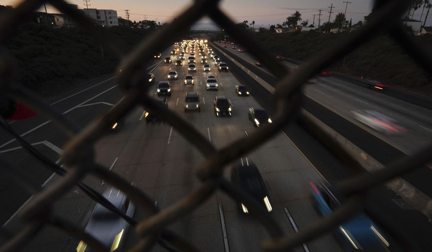 Traffic builds as cars make their way along a highway the day before Thanksgiving, Wednesday, Nov. 27, 2024, in San Diego. (AP Photo/Gregory Bull) ** FILE **