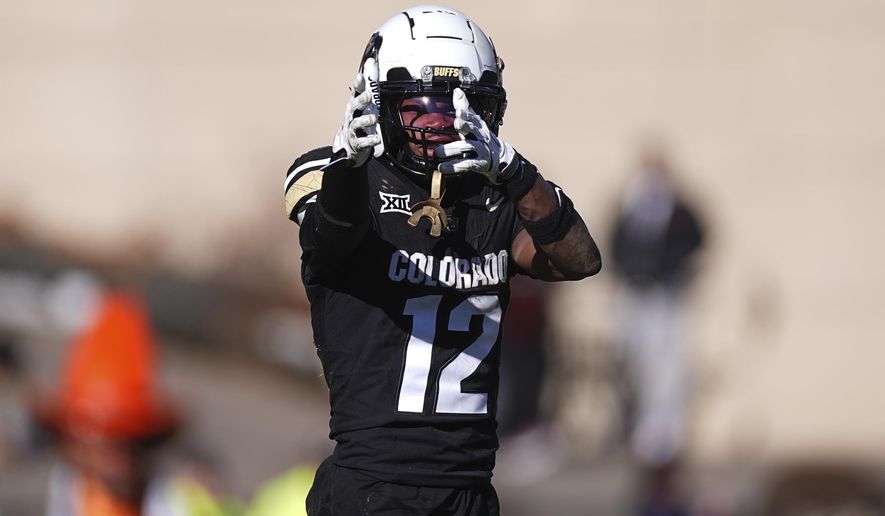 Colorado wide receiver Travis Hunter gestures after pulling in a pass for a first down in the second half of an NCAA college football game against Oklahoma State, Friday, Nov. 29, 2024, in Boulder, Colo. (AP Photo/David Zalubowski)