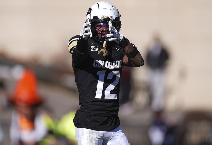 Colorado wide receiver Travis Hunter gestures after pulling in a pass for a first down in the second half of an NCAA college football game against Oklahoma State, Friday, Nov. 29, 2024, in Boulder, Colo. (AP Photo/David Zalubowski)