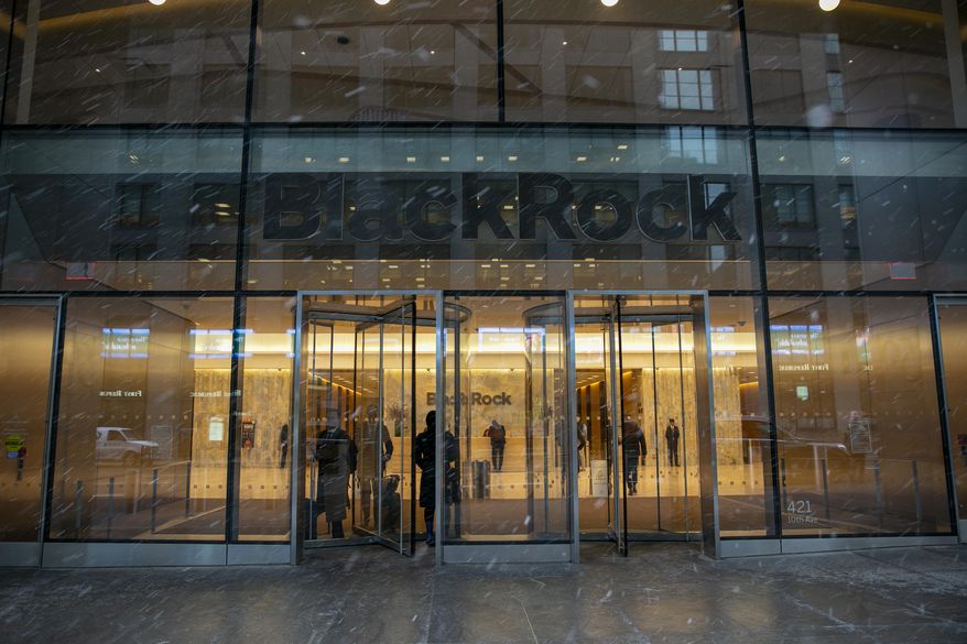 People walk in and out of the BlackRock investment company building in New York on March 14, 2023. (AP Photo/Ted Shaffrey, file)