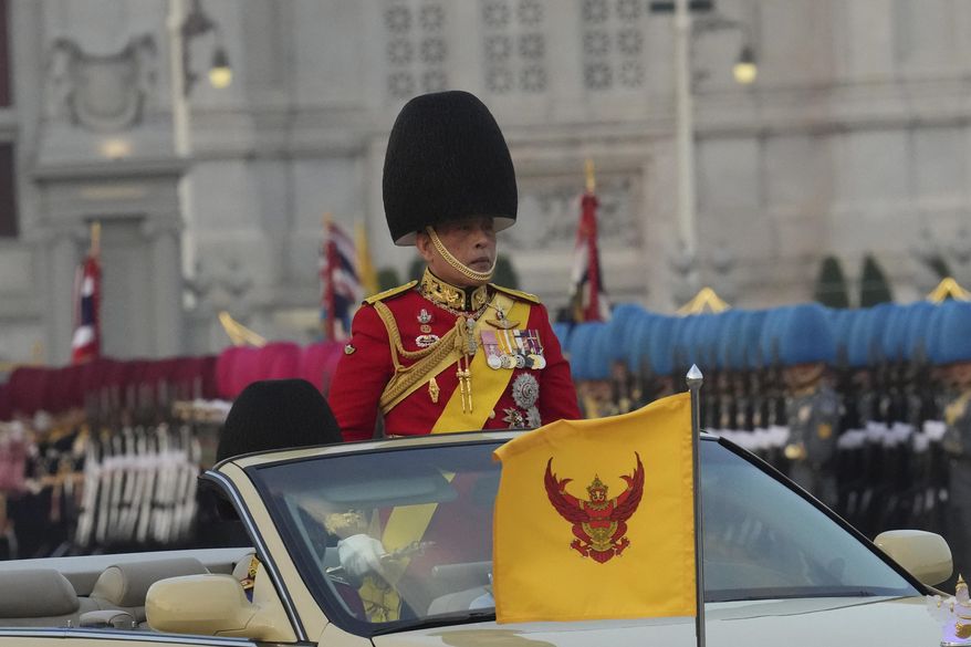 Thailand's King Maha Vajiralongkorn, reviews the honor guard in Bangkok, Thailand, Tuesday, Dec. 3, 2024. The parade as a part of celebrate the honor the King's 72nd birthday. (AP Photo/Sakchai Lalit)