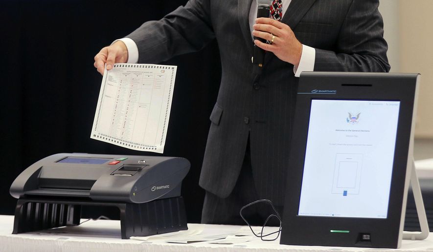 FILE - A Smartmatic representative demonstrates his company's system, which has scanners and touch screens with printout options, at a meeting of the Secure, Accessible & Fair Elections Commission, Aug. 30, 2018, in Grovetown, Ga. (Bob Andres/Atlanta Journal-Constitution via AP, File)