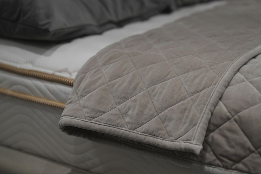Weighted blankets on display in a Saatva mattress showroom in New York, Dec. 4, 2024. (AP Photo/Mary Conlon)